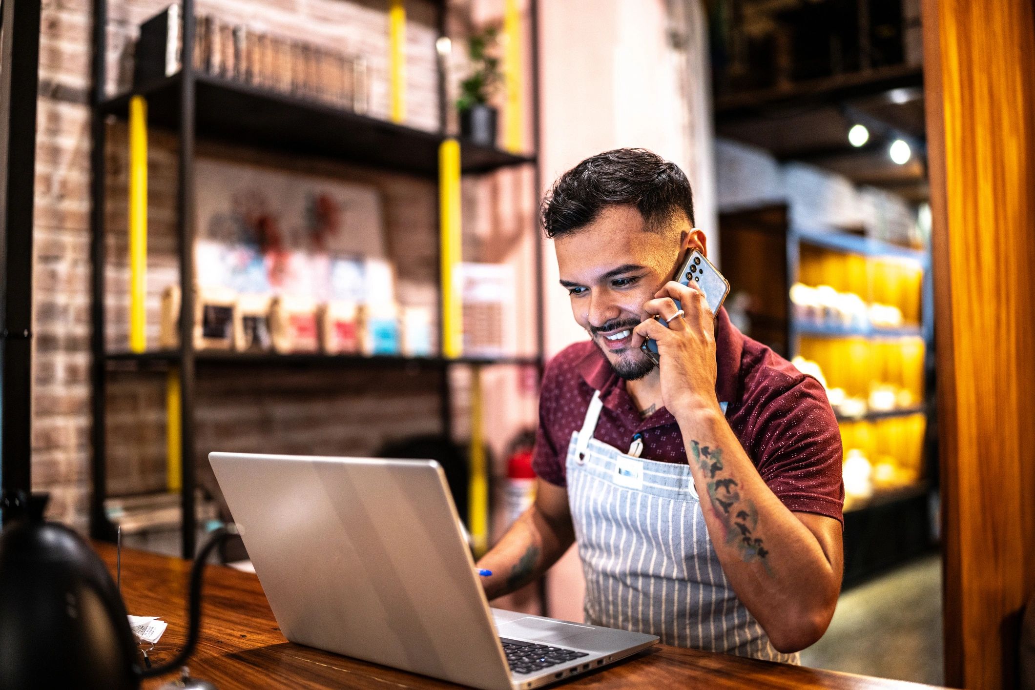 Small business owner using a laptop representing an AI assistant demo